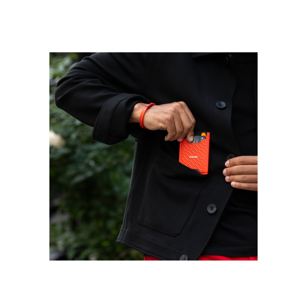 Stylish guy wearing a MANIMIRI Spring card holder in orange in Soho New York